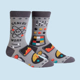 A pair of men's crew socks with a geometric pattern and the text 'GENIUS AT WORK' on the top.